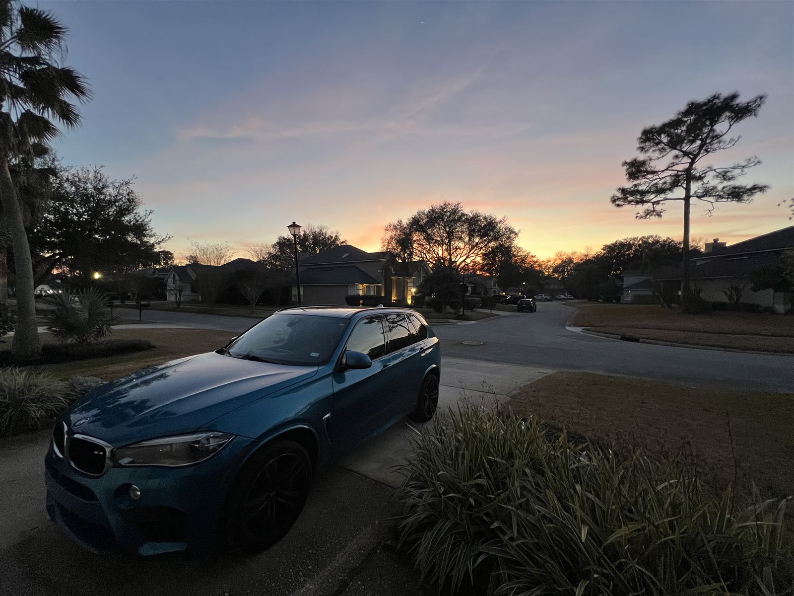 Tideline Carpet Care blue BMW X5 parked at dusk in a Jacksonville Beach neighborhood